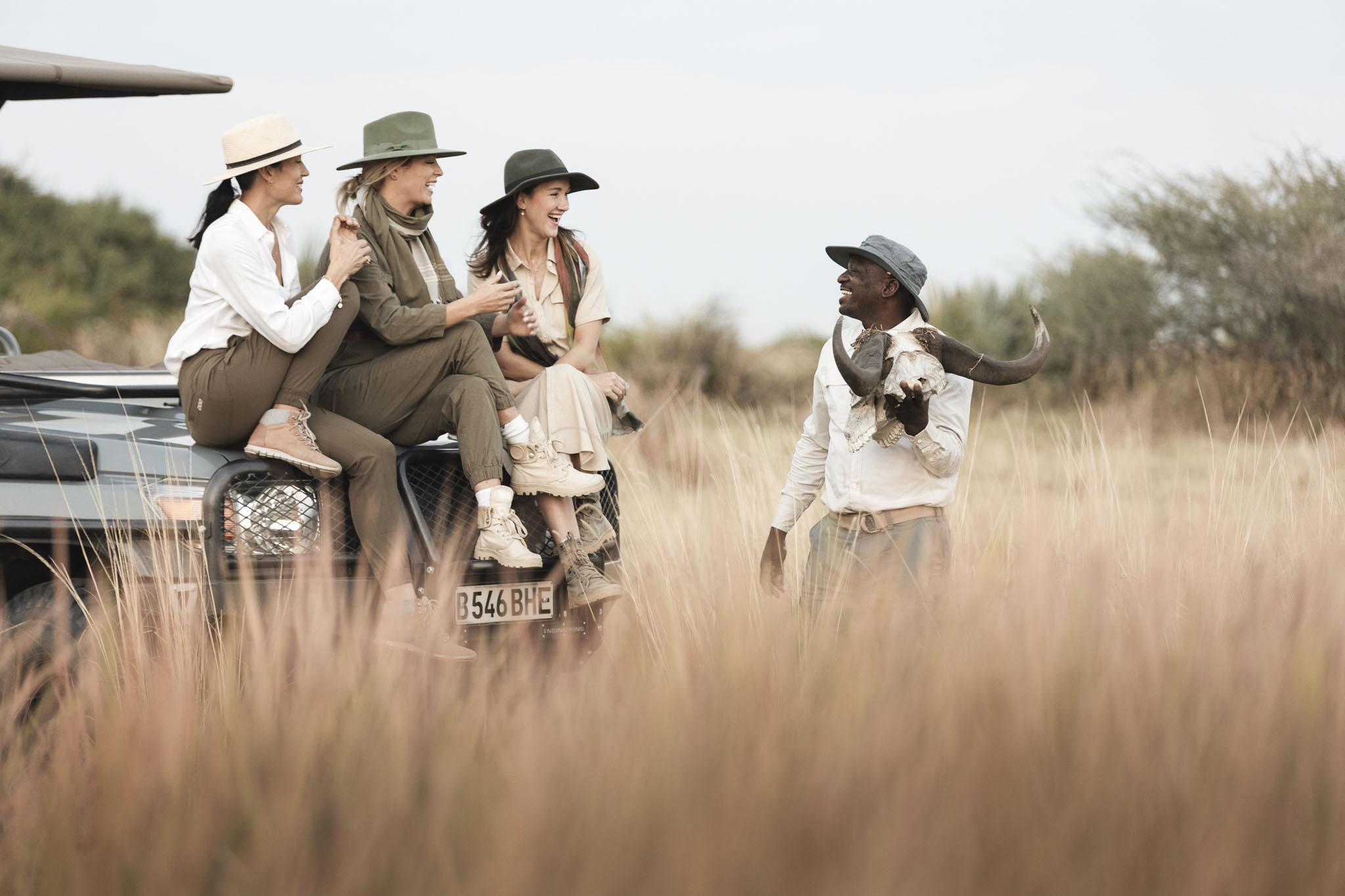 guide showing lady guests a buffalo skull at little mombo camp Botswana
