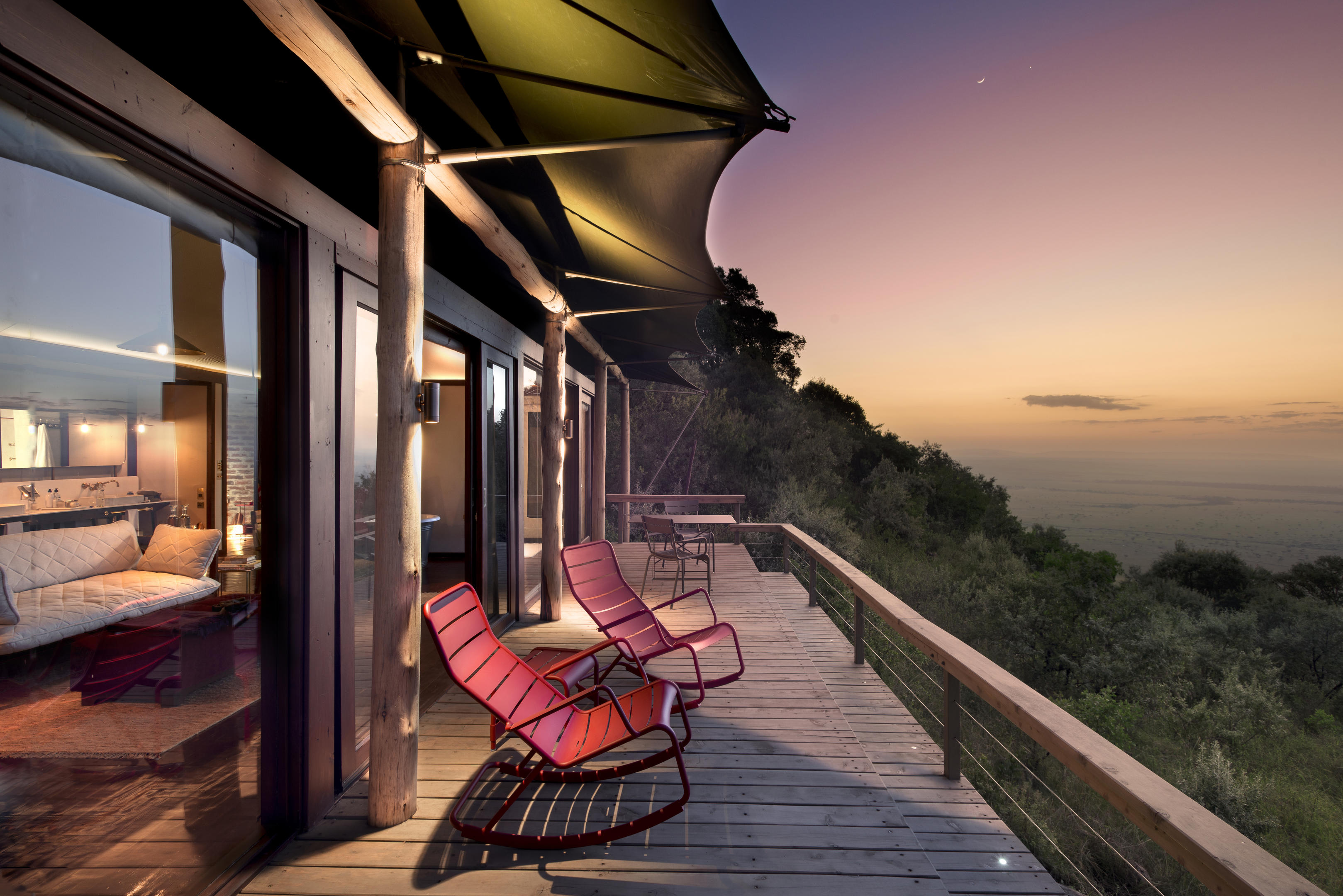 sunset view of deck with rocking chairs of a suite at Angama Mara Kenya Masai Mara