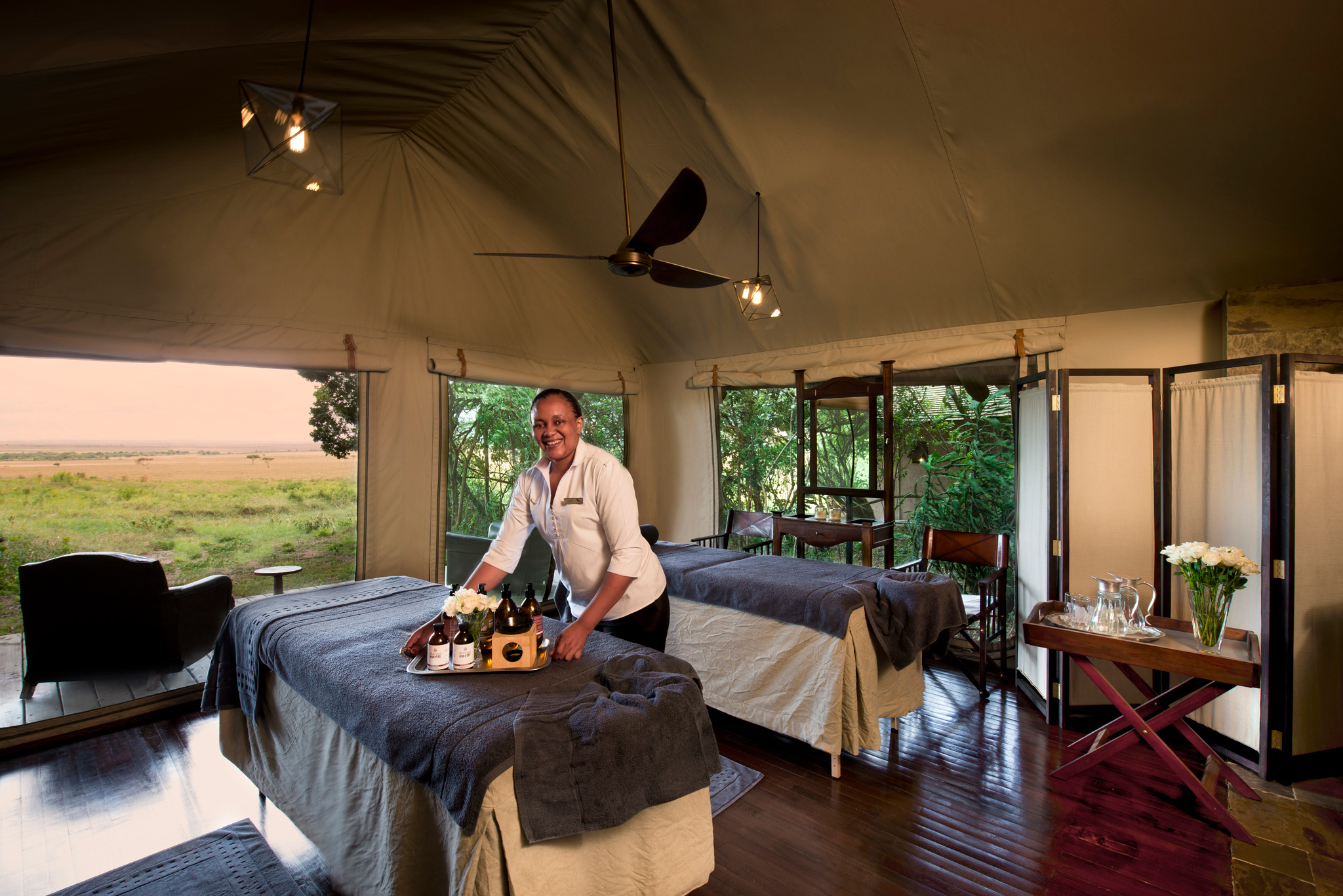 treatment room with beds and staff in spa of andbeyond Bateleur camp Kenya Masai Mara