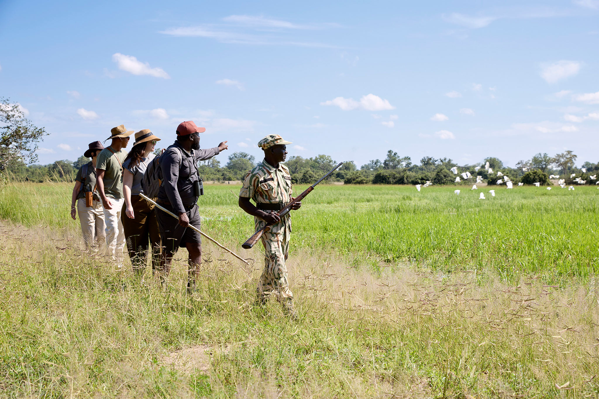 walking safari with guests and guides at Chichele Presidential Lodge Zambia