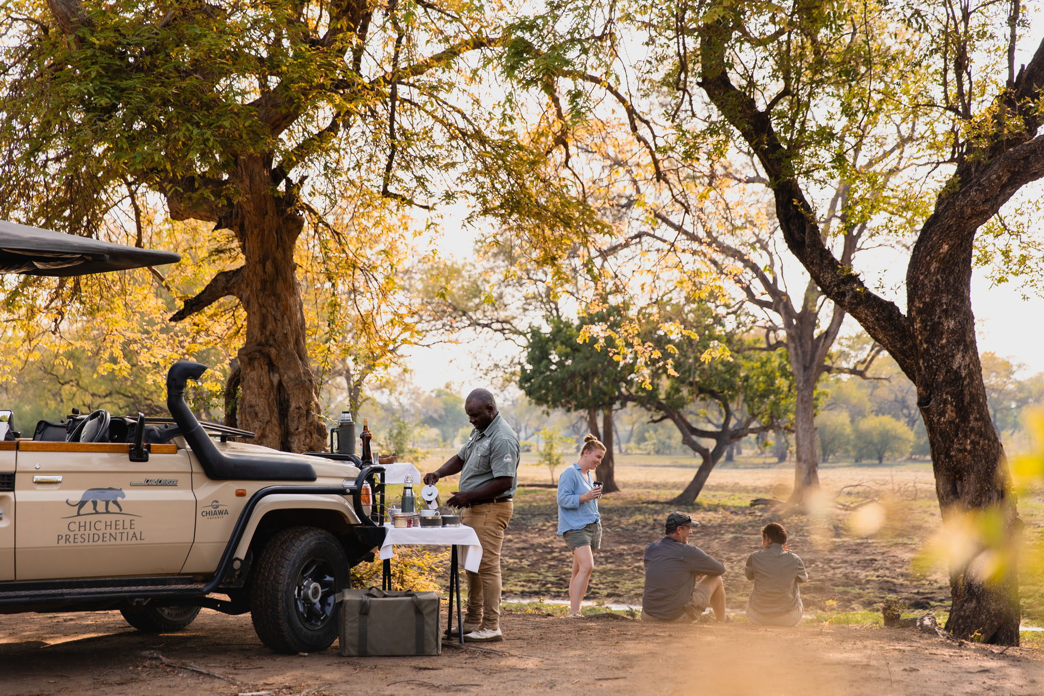 sundowners under a tree with the guide at  Chichele Presidential Lodge Zambia