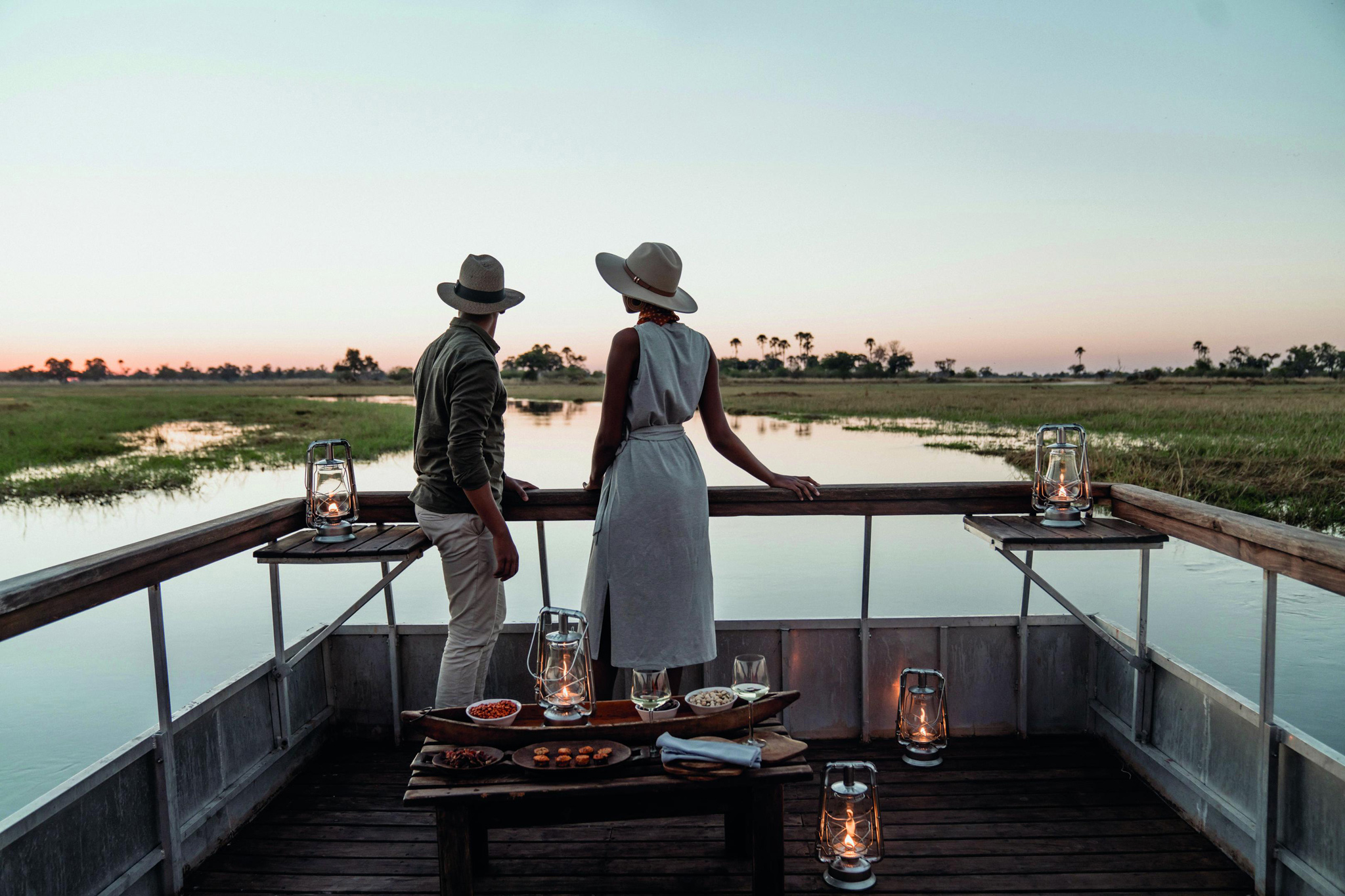 couple having sundowners on boat at eagle island lodge