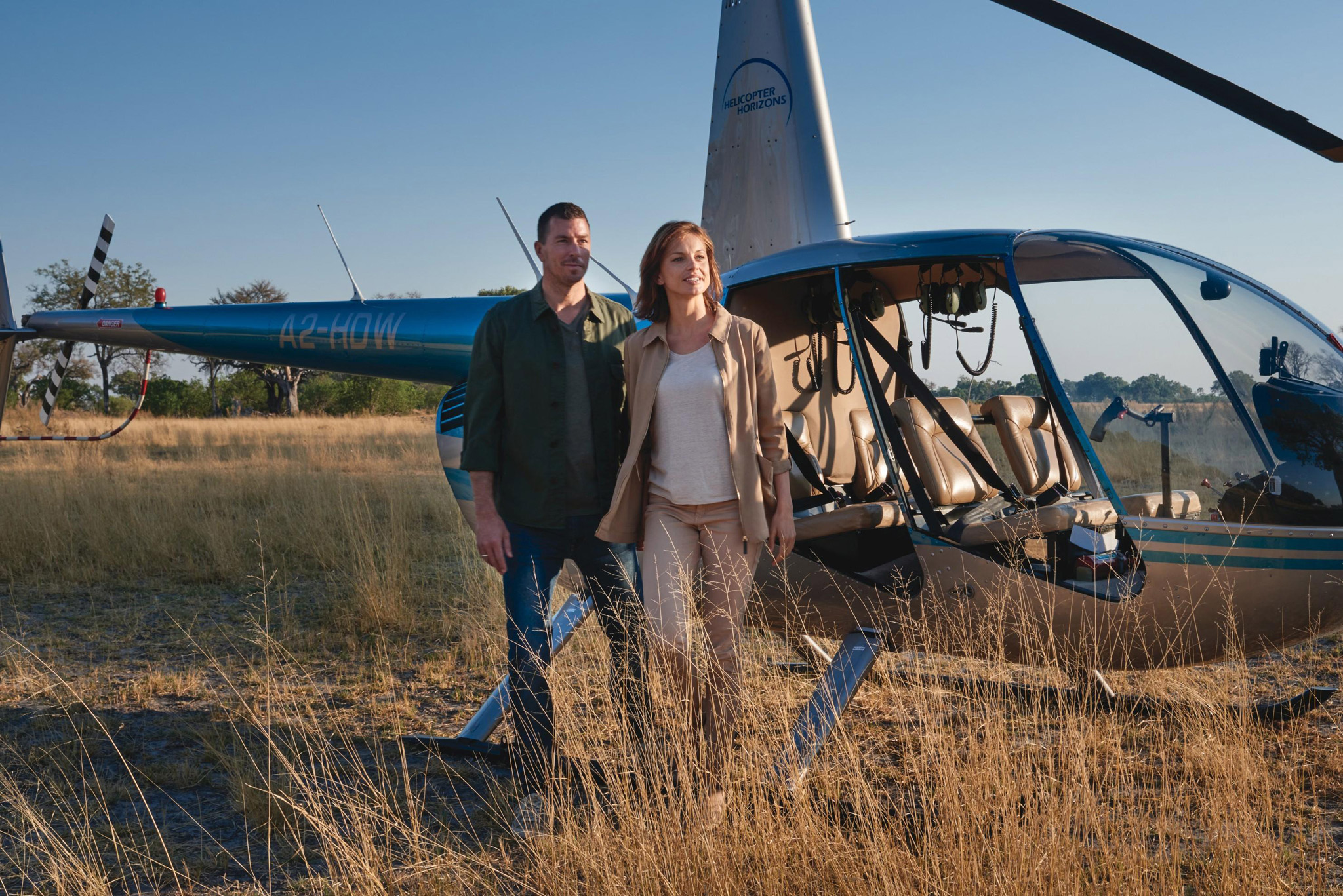 couple standing by helicopter at eagleisland lodge