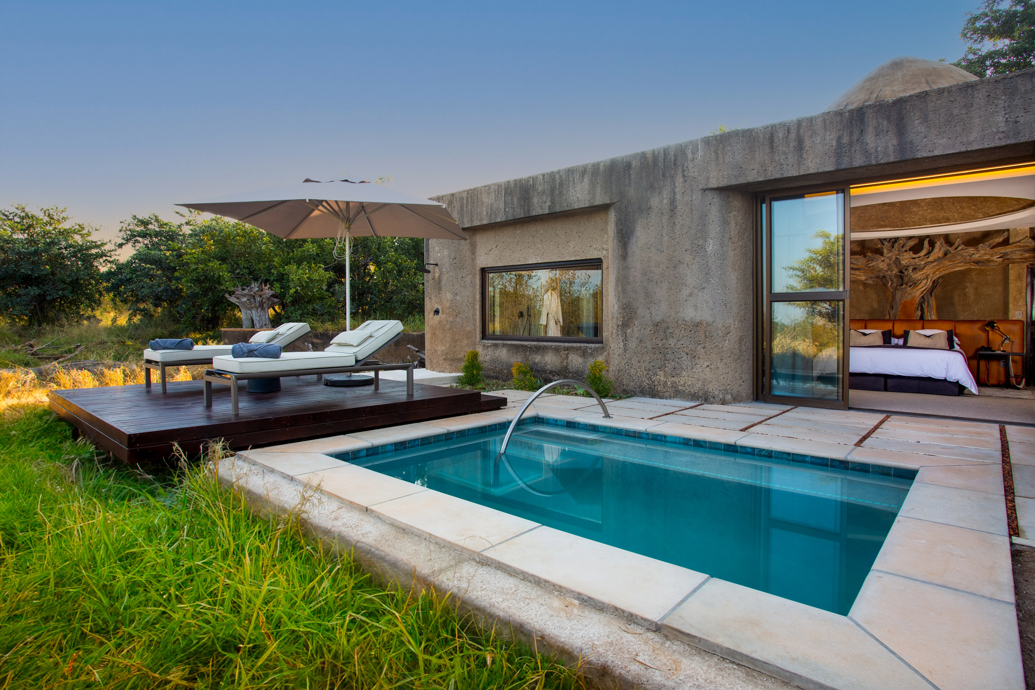 outside of suite with plunge pool and deck at earth lodge Sabi Sabi