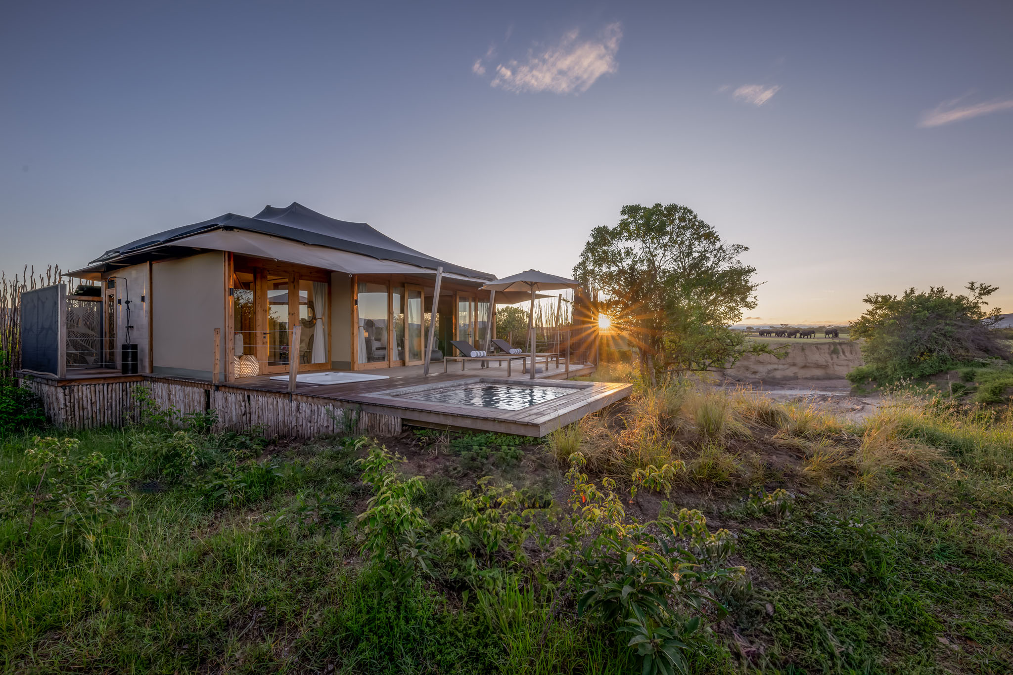 evening view of the exterior of the honeymoon suite at the JW Marriot Masai Mara Kenya