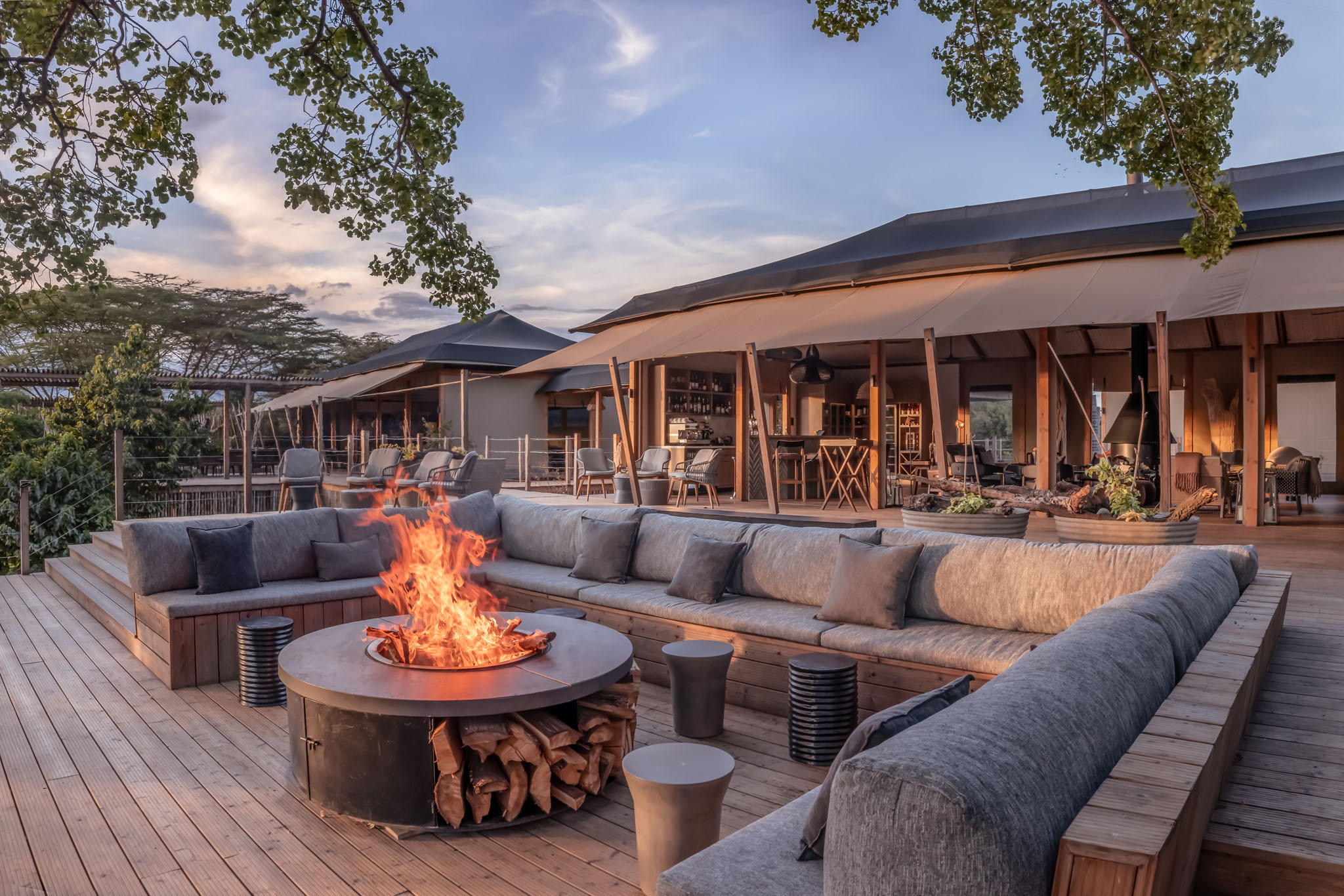 view of the fire pit at fig tree lounge at sunset by the JW Marriot Masai Mara Kenya
