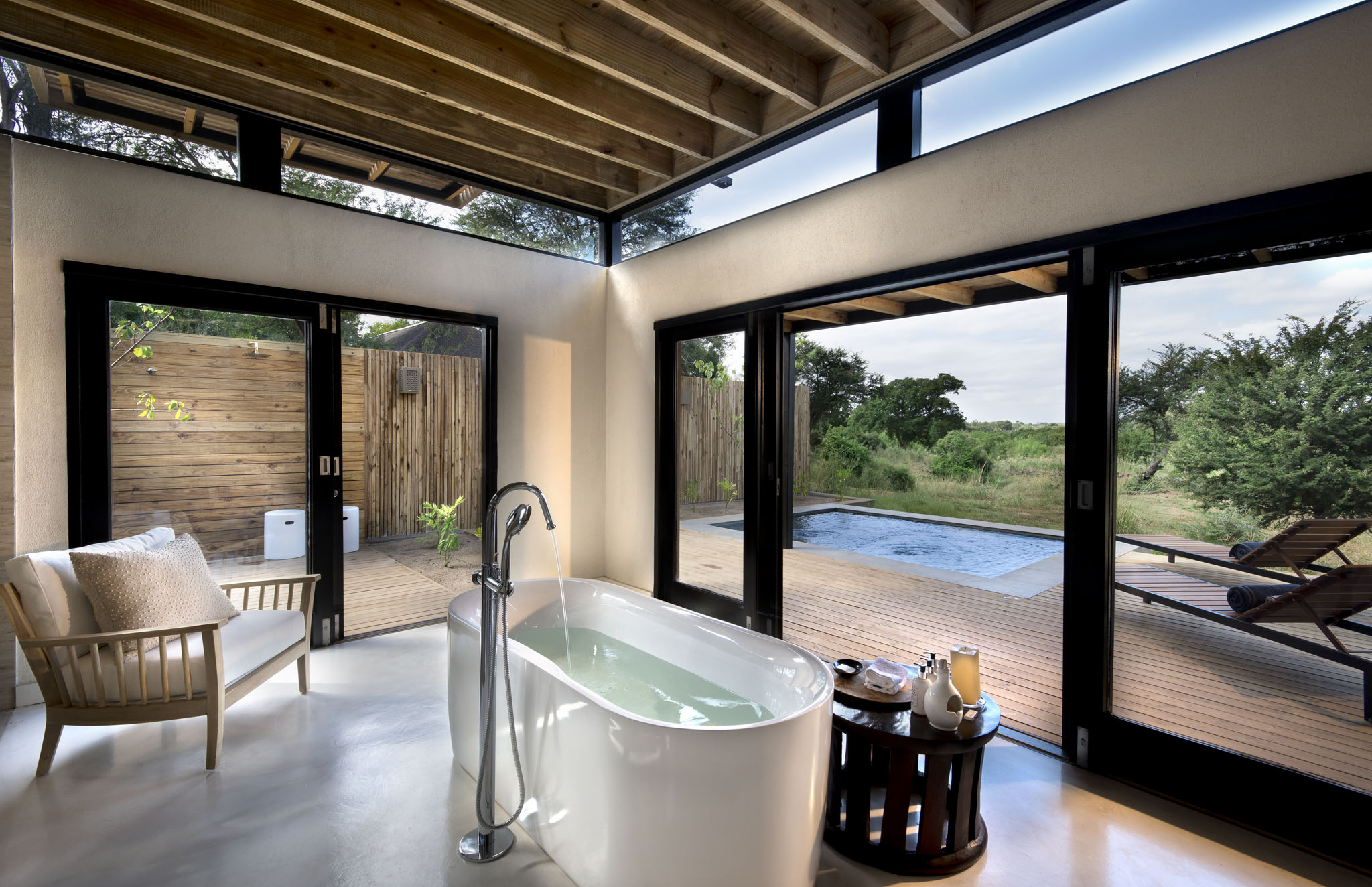 bathroom view with splash pool and deck at Lion Sands Game reserve River Lodge