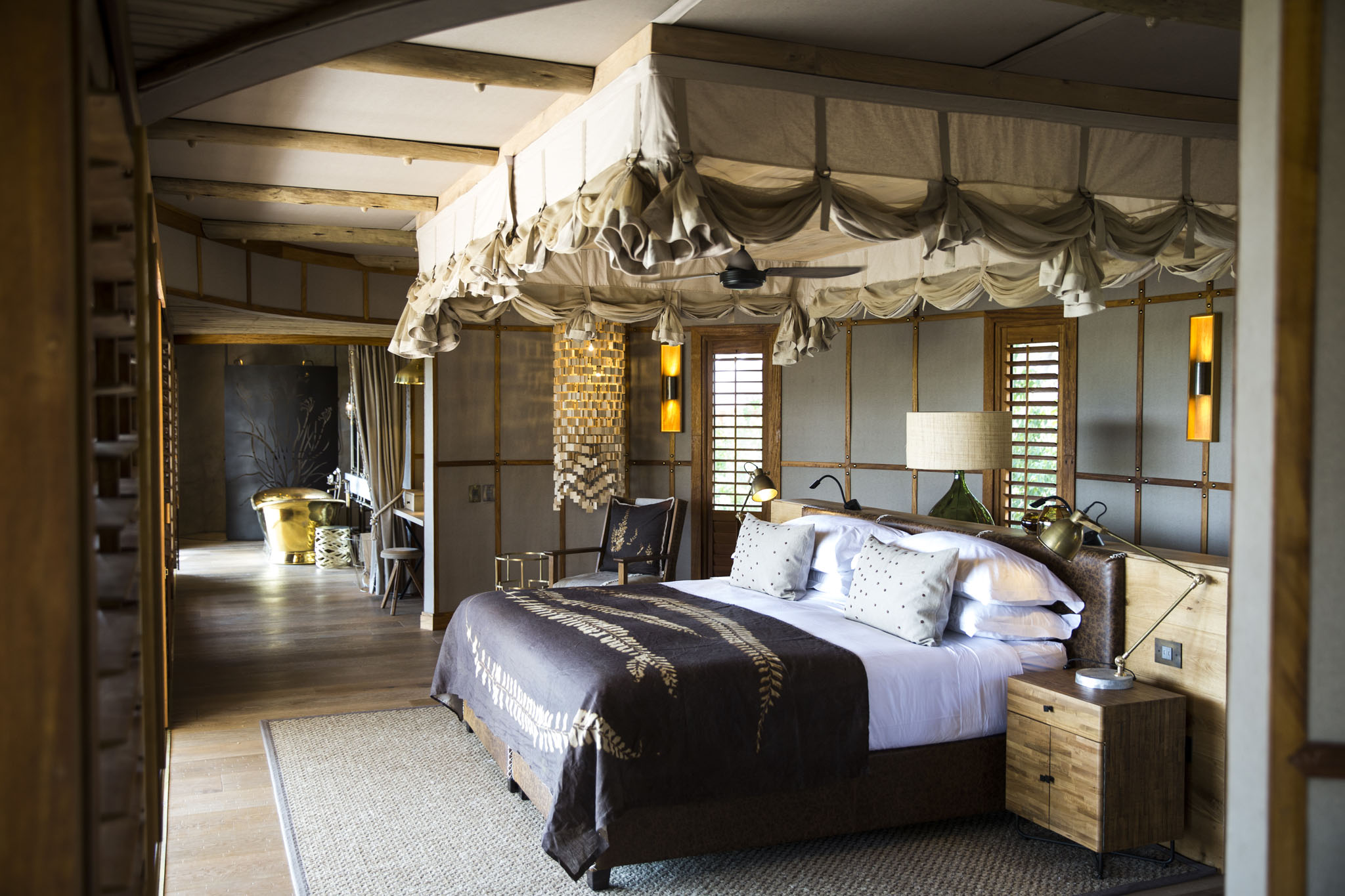 interior view of room with four poster bed at little mombo camp Botswana
