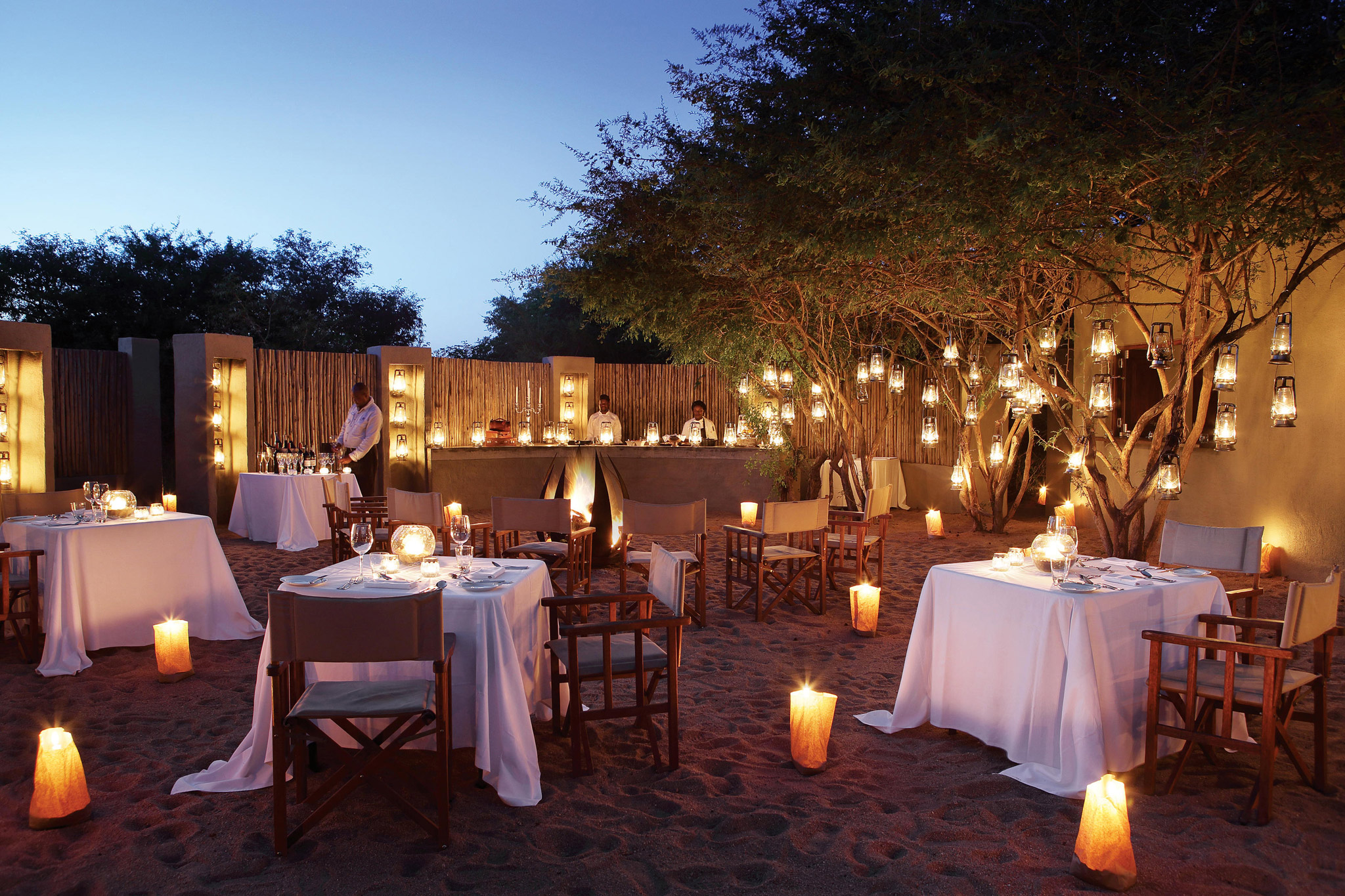 dinner setting with tables in fireplace boma of Pioneer camp Lodolozi