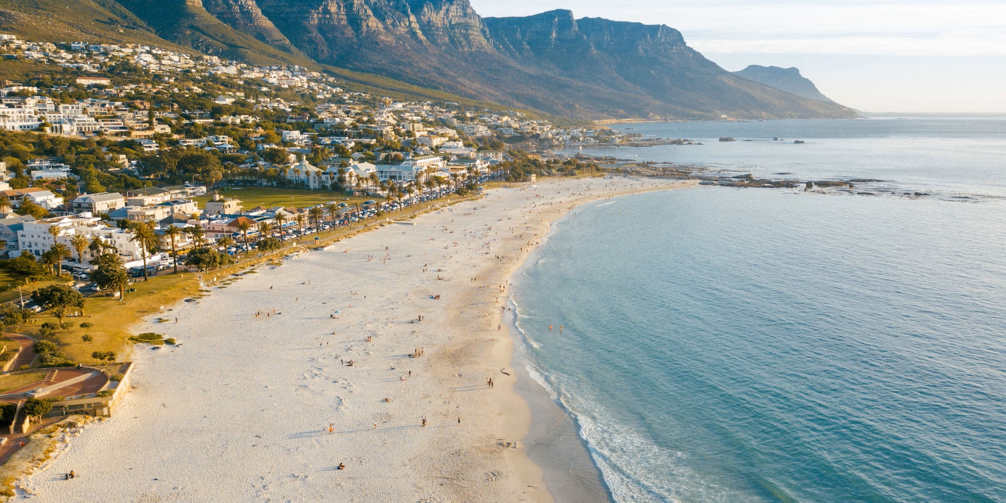 aerial view of camps bay beach with ocean and mountains surrounding