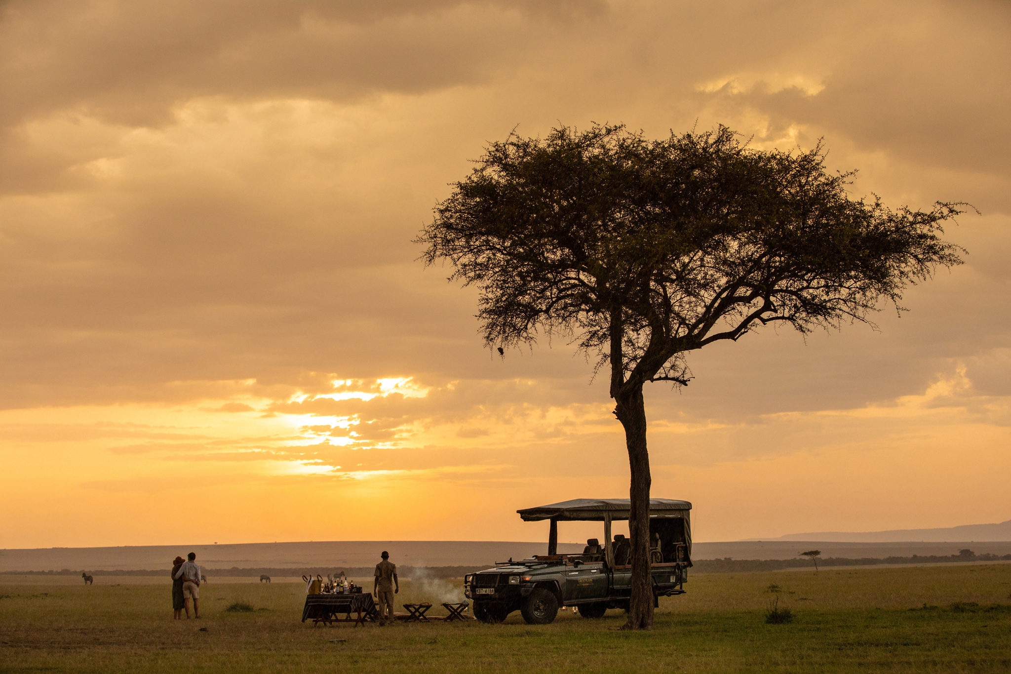 sunset on the plains for sundowners by safari vehicle at Mara Plains Camp Kenya Masai Mara