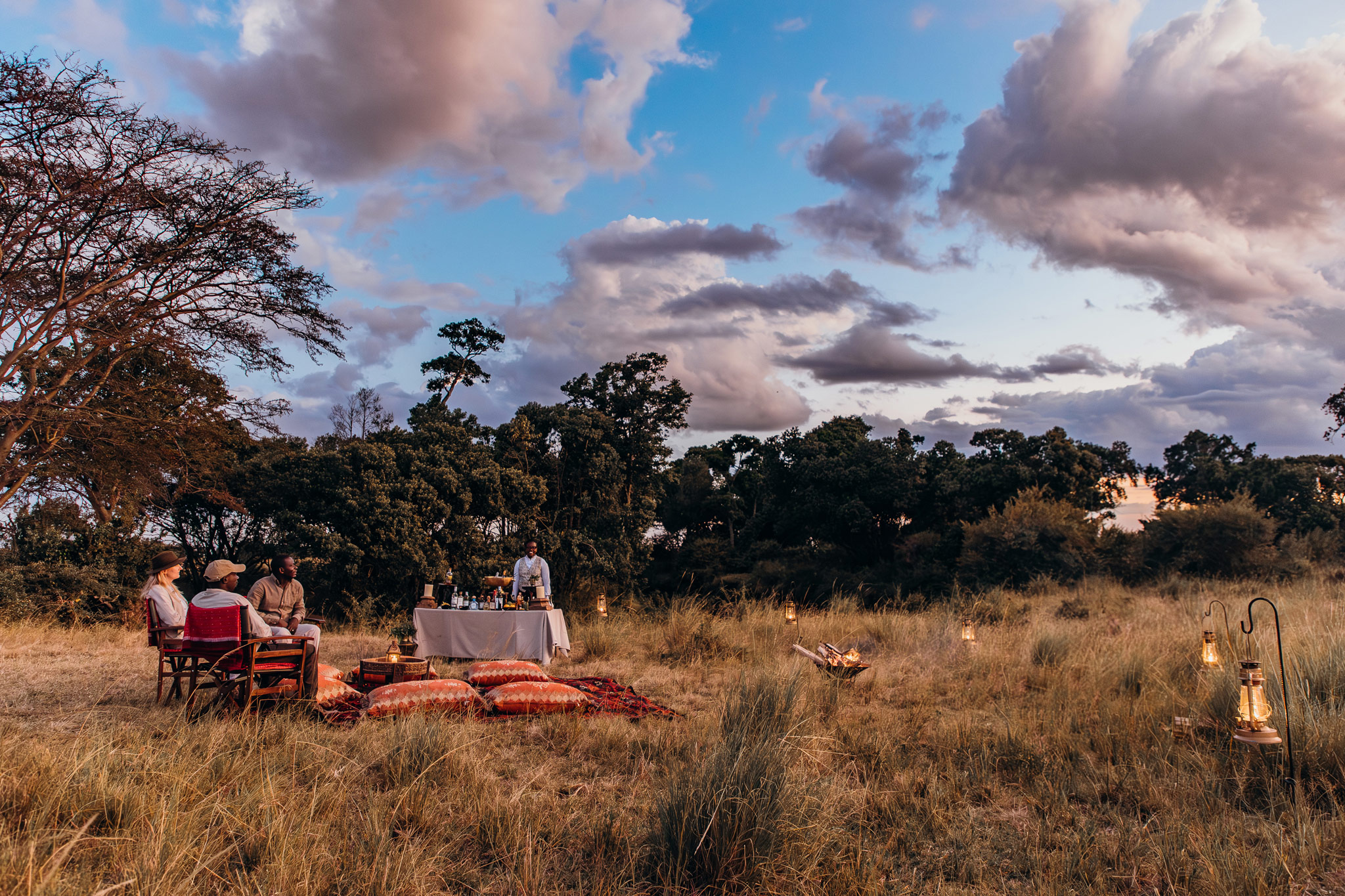 bush dinner setting with guests at Mara Plains Camp Kenya Masai Mara