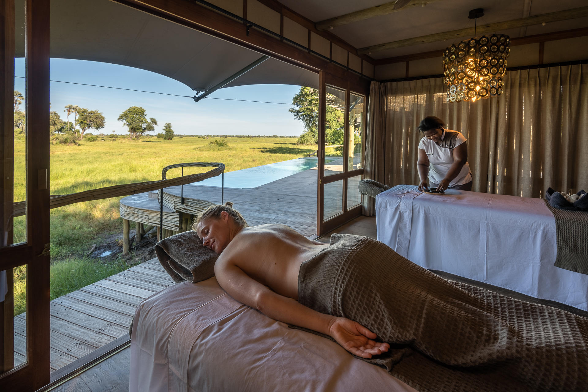 lady on spa bed at Mombo Camp Wilderness Okavango Delta