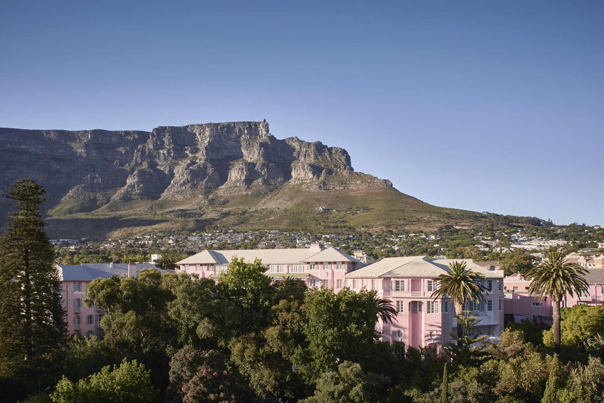 exterior view of the Mount Nelson Hotel Cape Town underneath table mountain in background