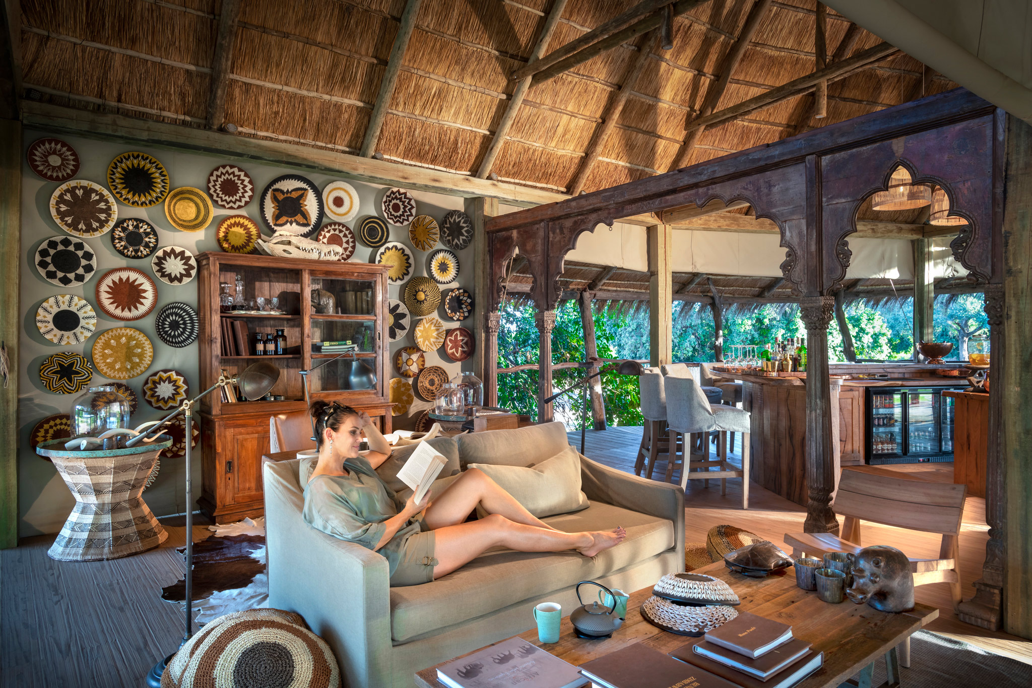 lady reading on couch in lounge of Nyamatusi Camps Mana Pools Zimbabwe 