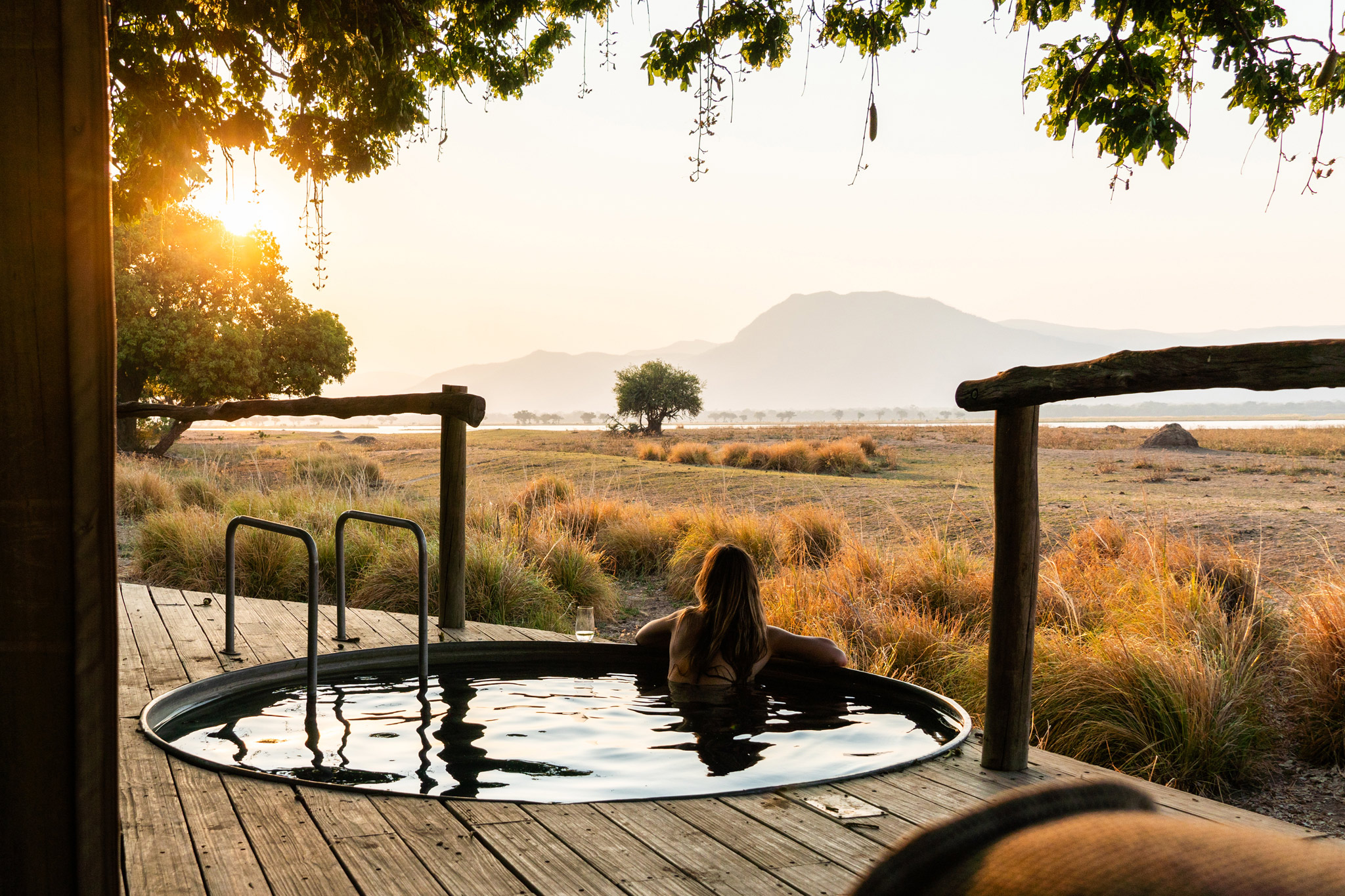 lady in splash pool on deck of suite by Nyamatusi Camps Mana Pools Zimbabwe 