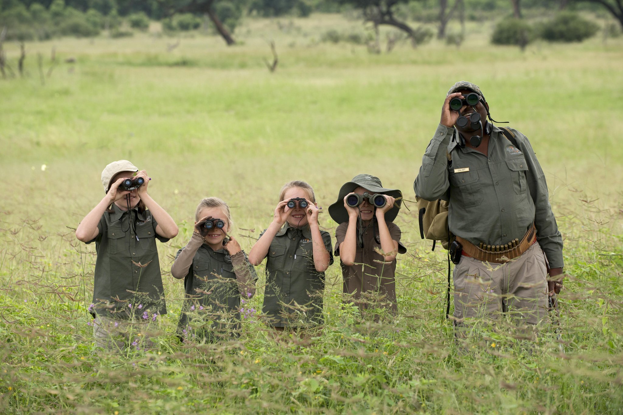 kids with ranger with binoculars getting schooled at Nyamatusi Camps Mana Pools Zimbabwe 