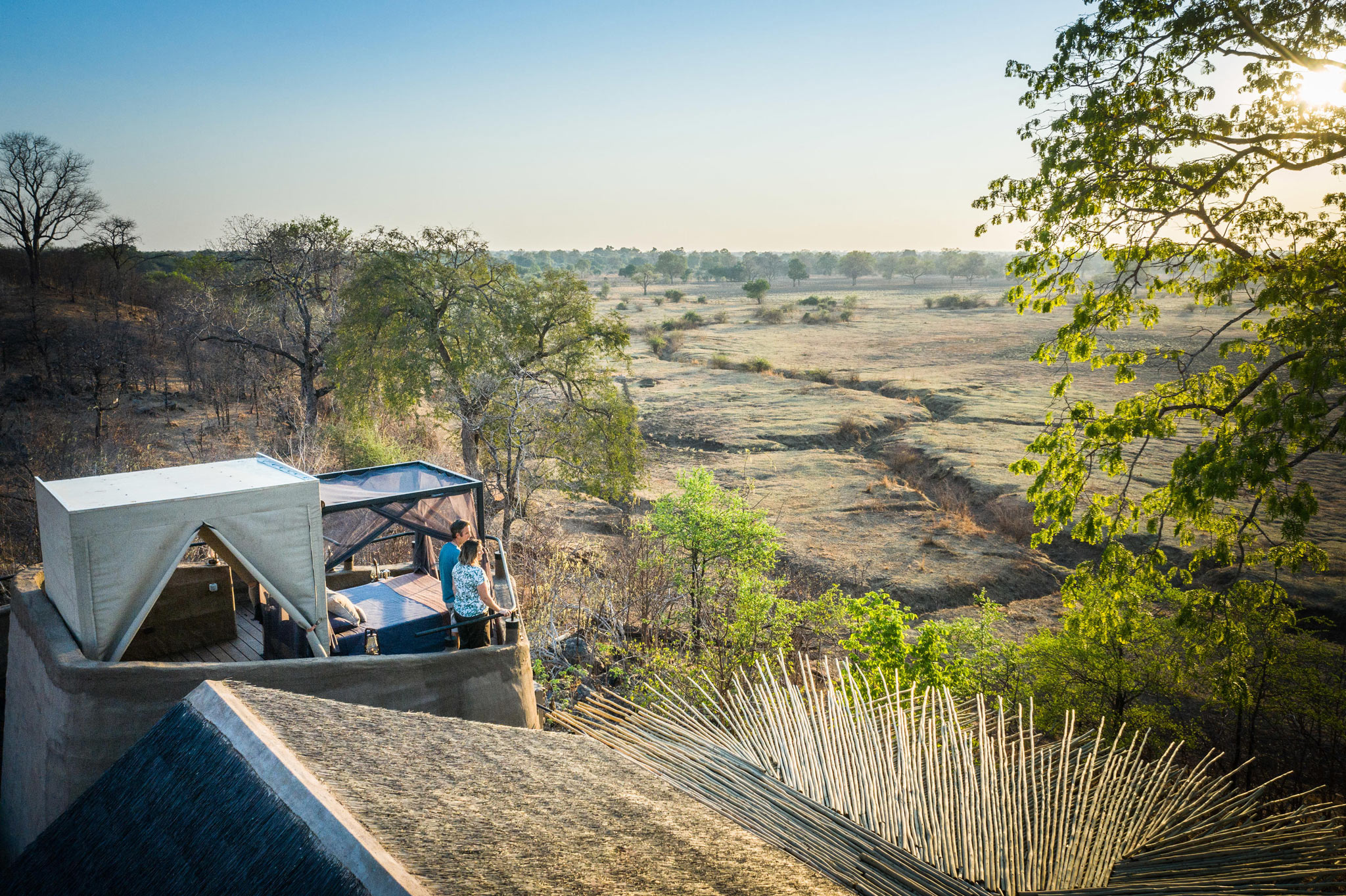 couple by starbed at daytime overlooking plains at Puku Ridge Camp Zambia