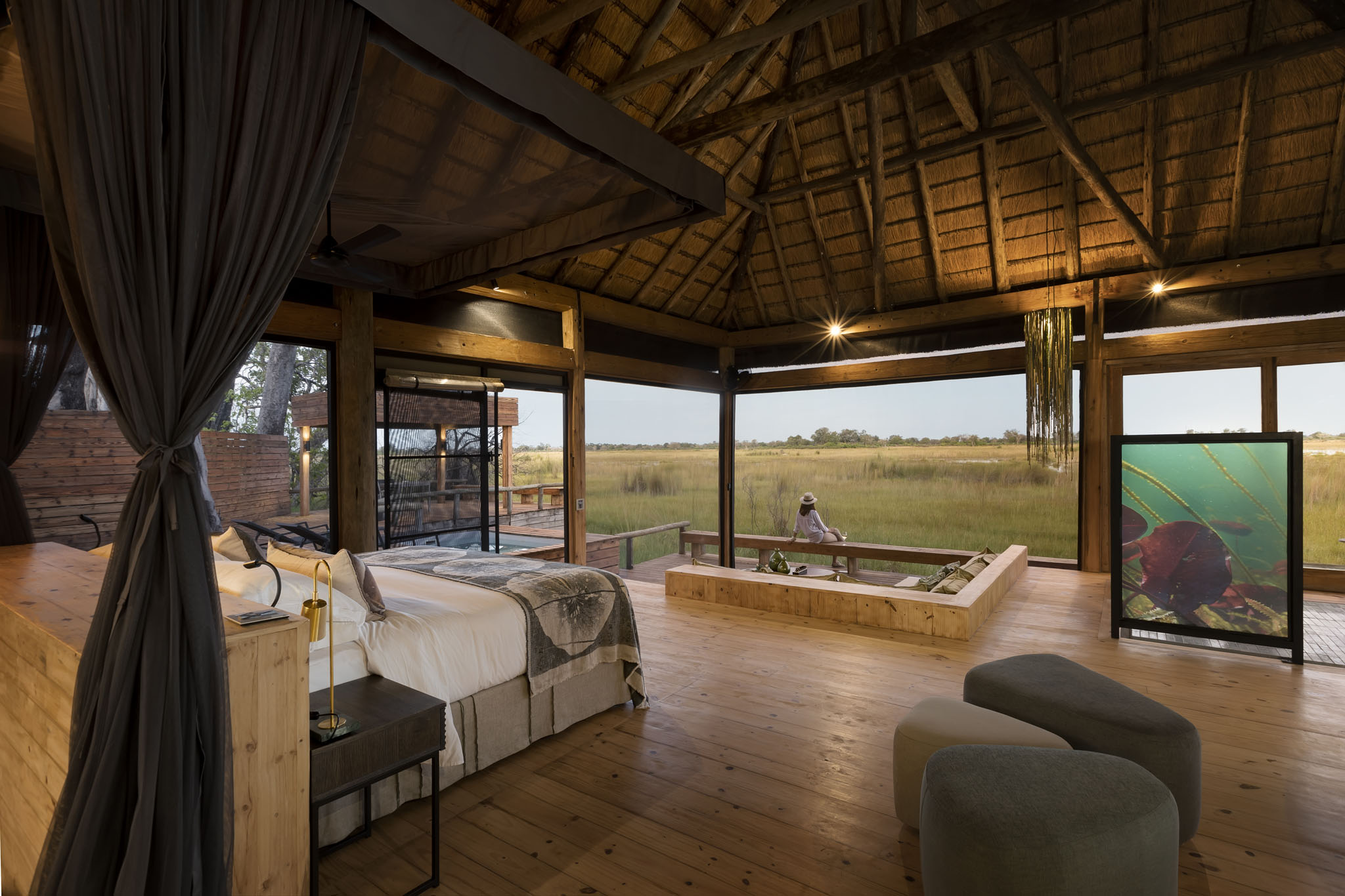 interior view of safari room with viewing deck beyond at Vumbura Plains Camp Wilderness Okavango Delta