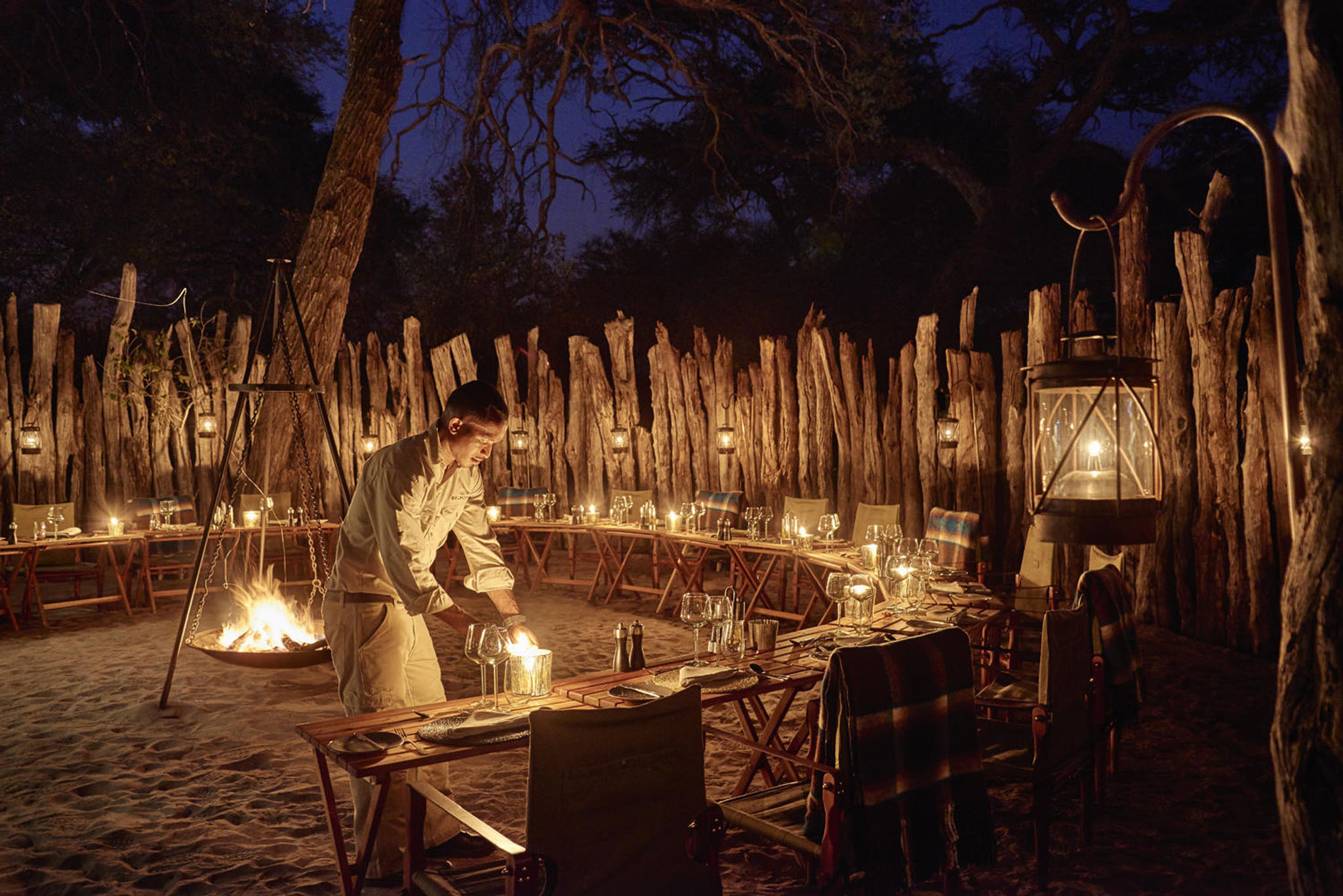 staff preparing boma and fire pit for supper at savute elaphant lodge okavango delta