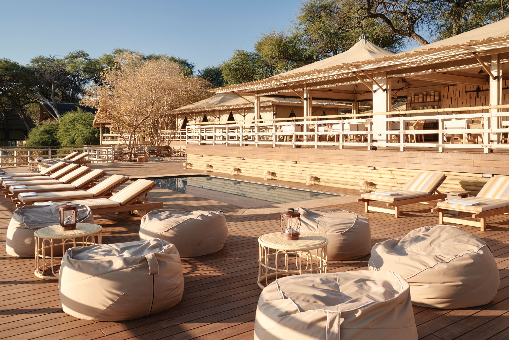 viewing deck with loungers and chairs at Savute elephant lodge by Belmond