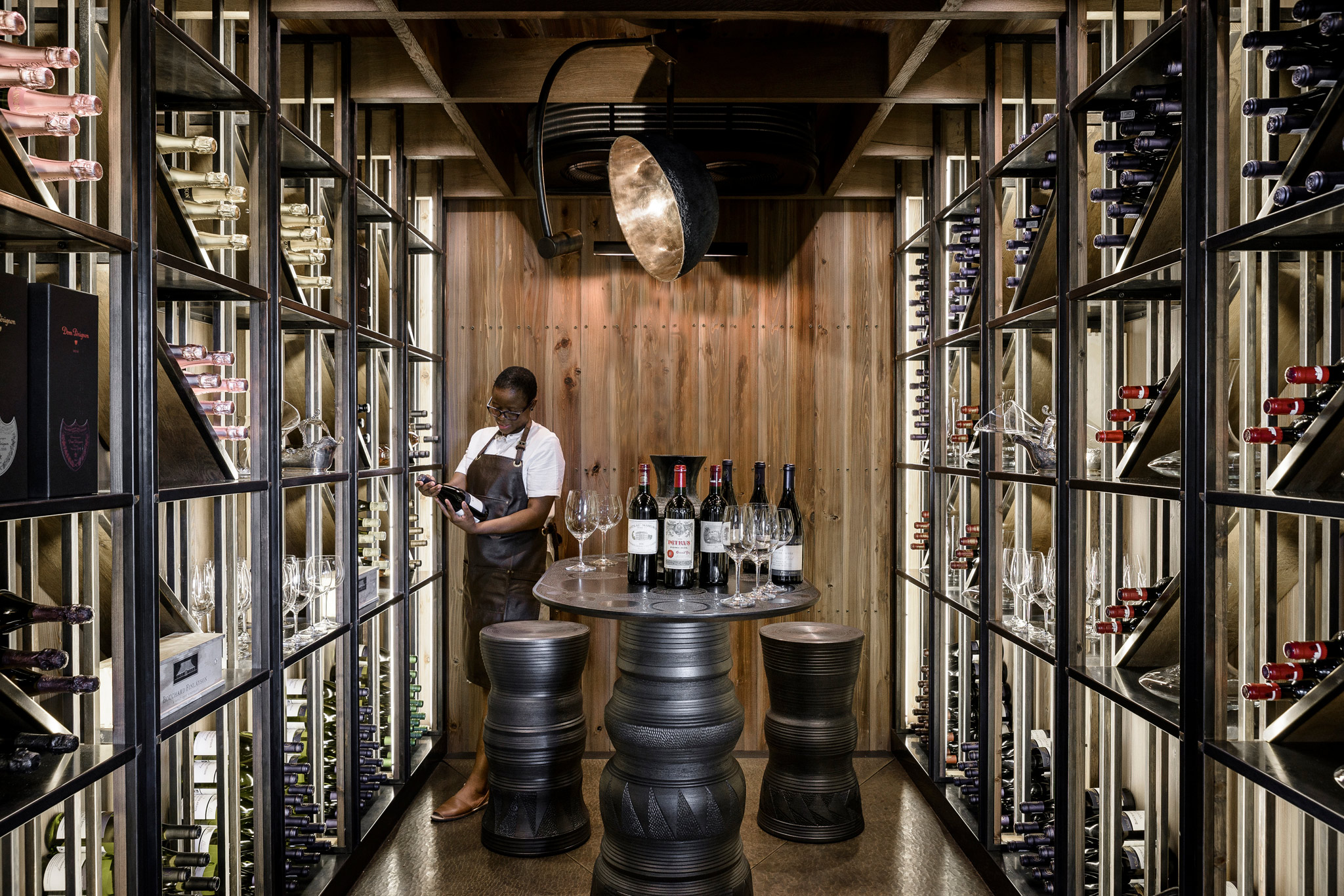 somelier choosing wine at xigera lodge wine cellar