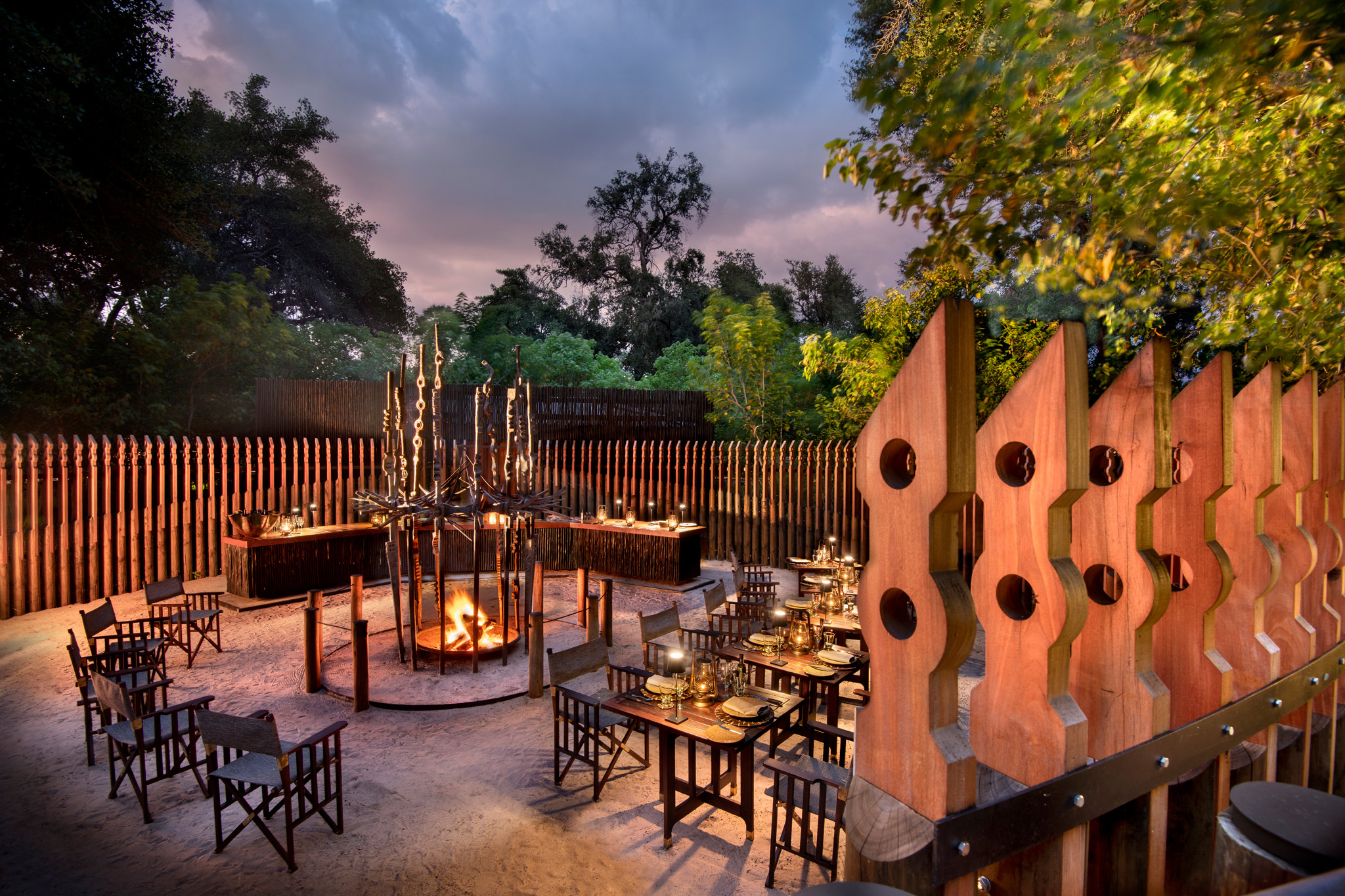 Fireplace and dinner area in outside boma of Xigera safari lodge Botswana