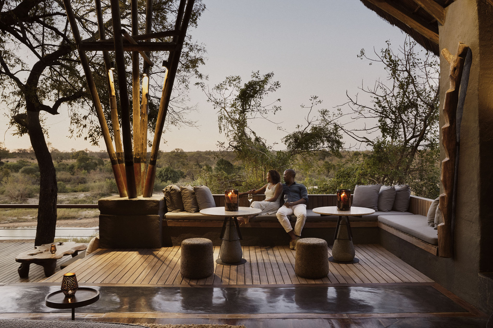 guests on deck of lounge by singita boulders lodge