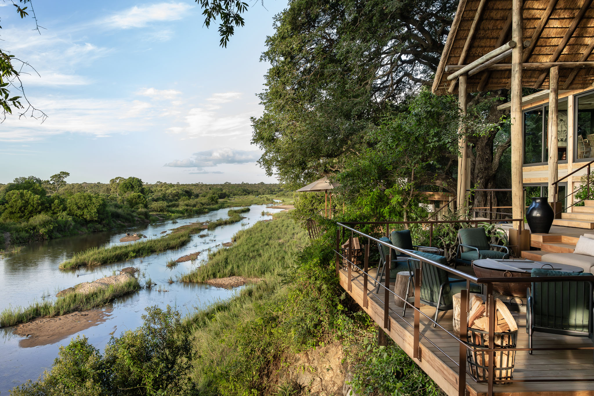 firedeck with view of river in morning at singita ebony lodge