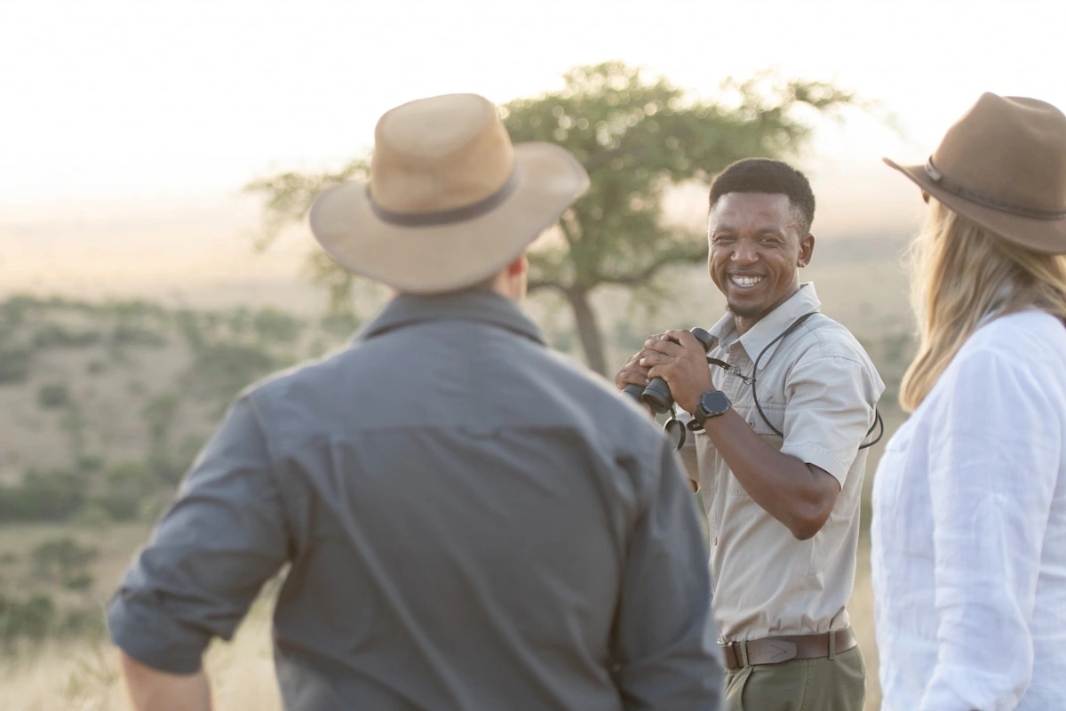 guests and ranger on a walking safari by Singita Sabora Tented Camp Serengeti 