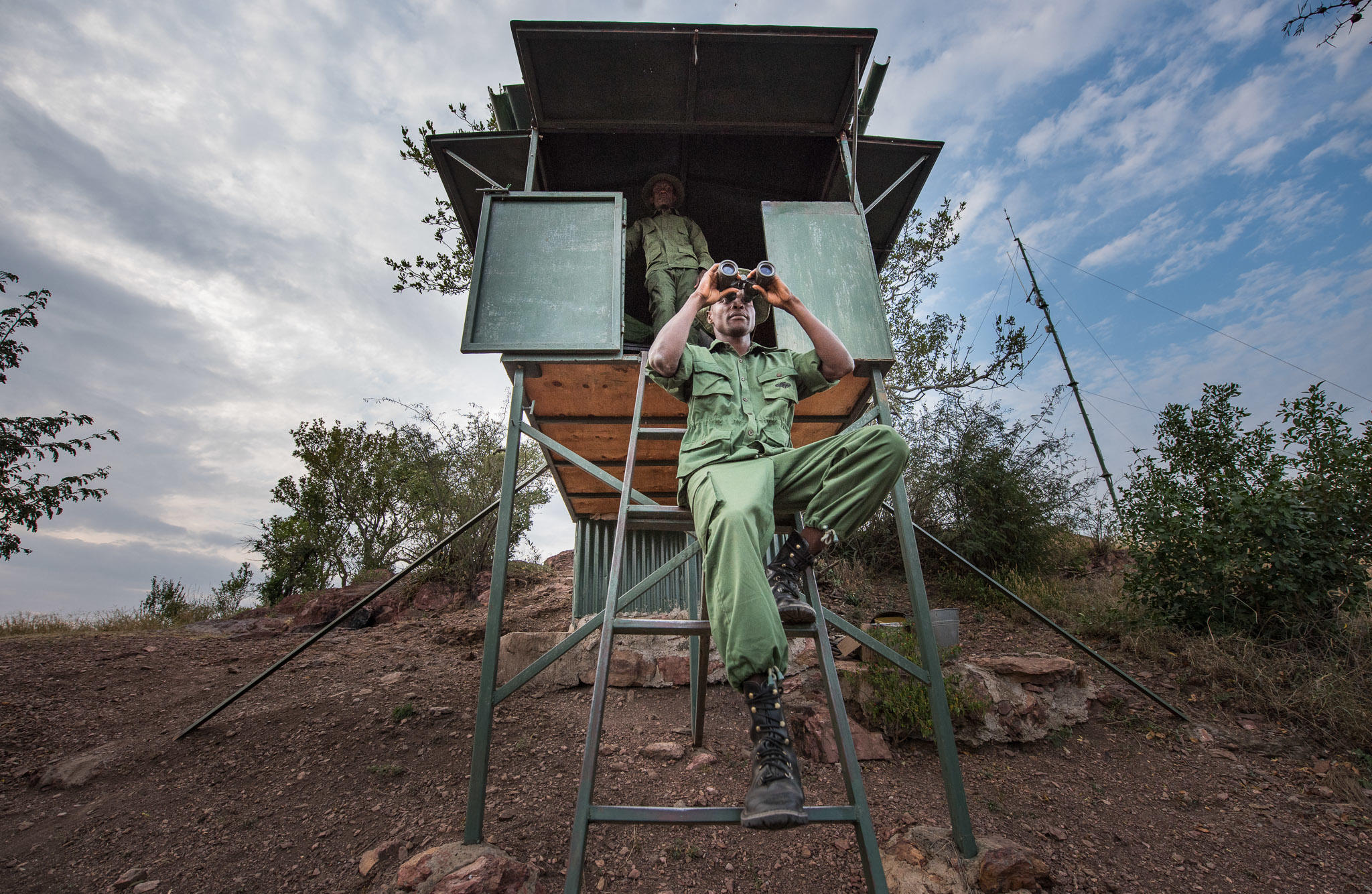 anti poaching guide looking out from post at Singita Sasakwa lodge in Serengeti