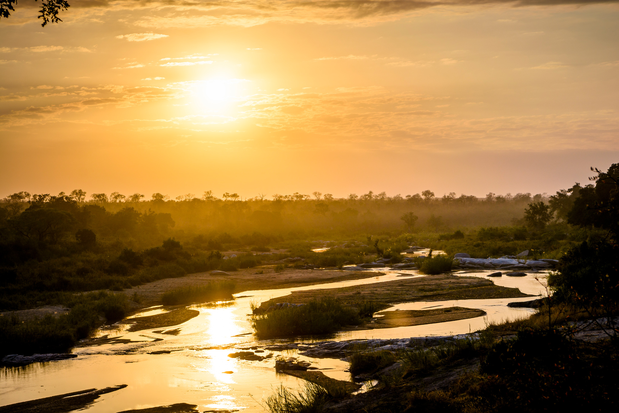 sunset view of the river at singita luxury lodge