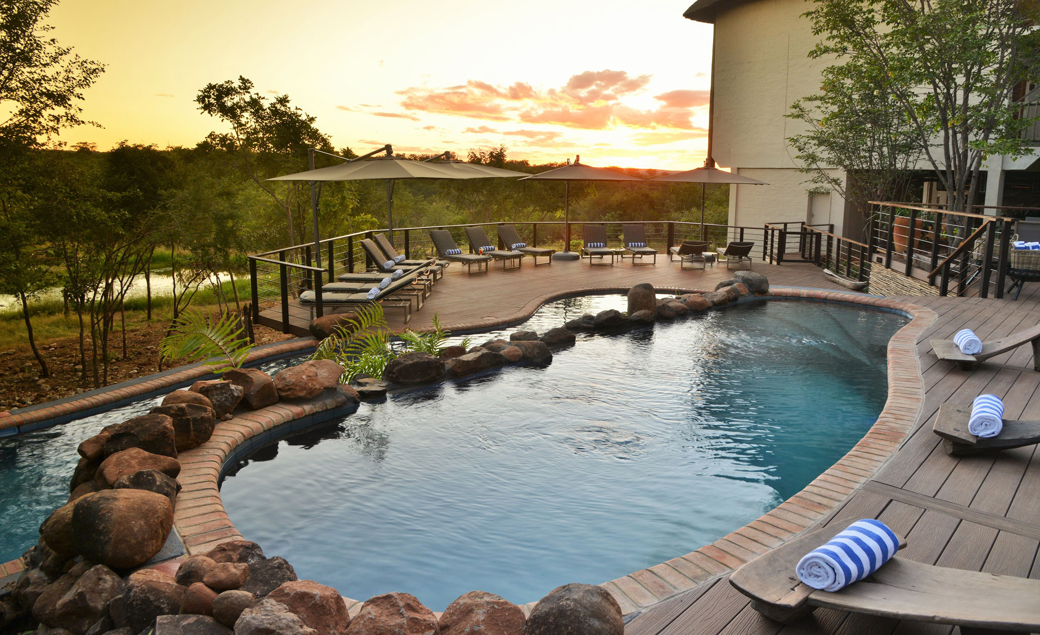 view of pool and loungers at victoria falls safari lodge