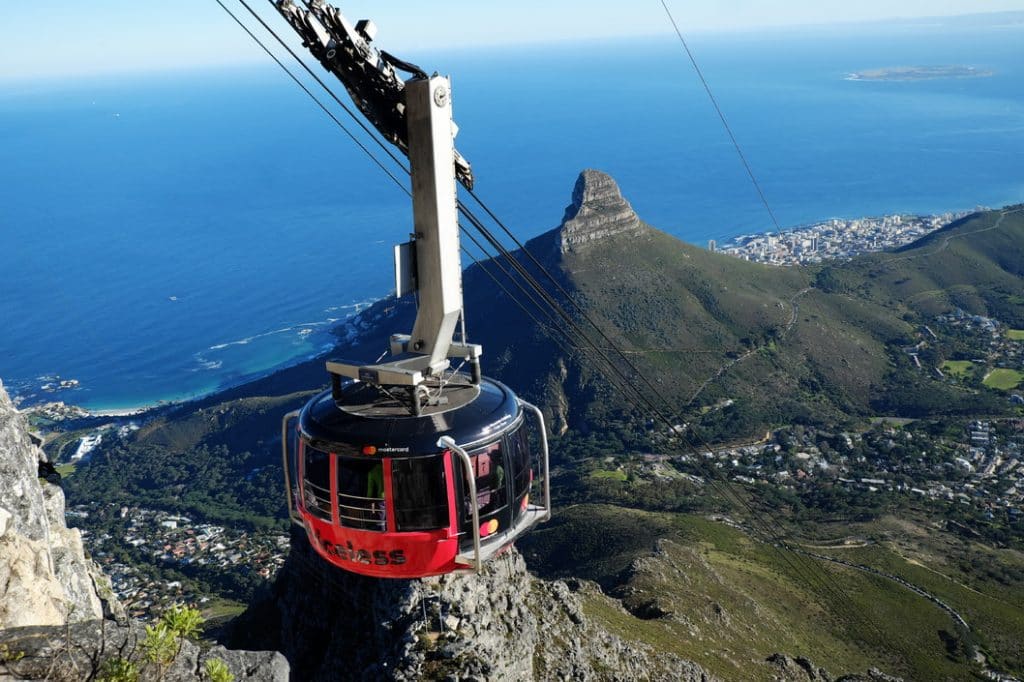 red cable car suspended above leeukop cape town