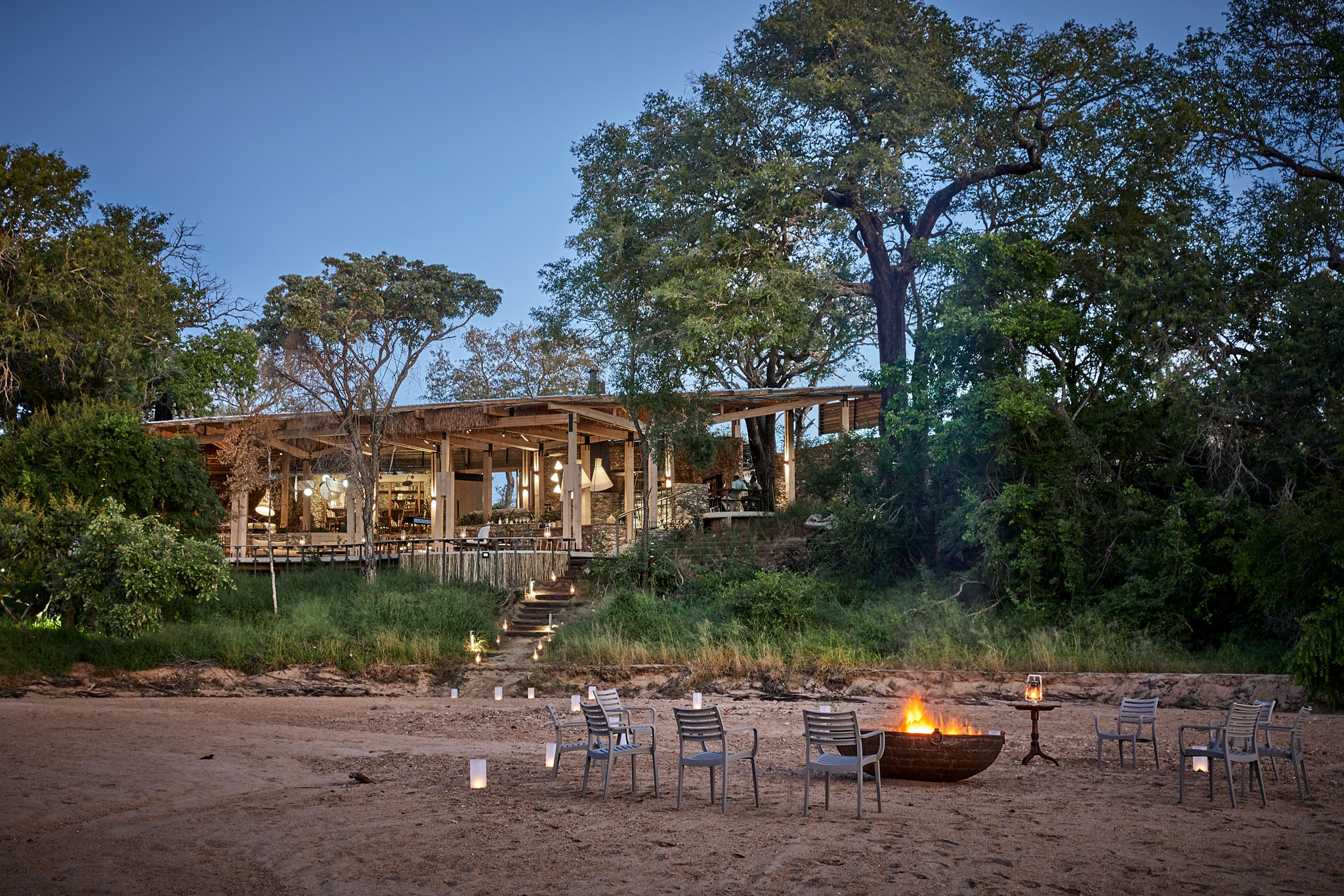 fireplace in riverbed in front of Thornybush saseka tented camp at sunset