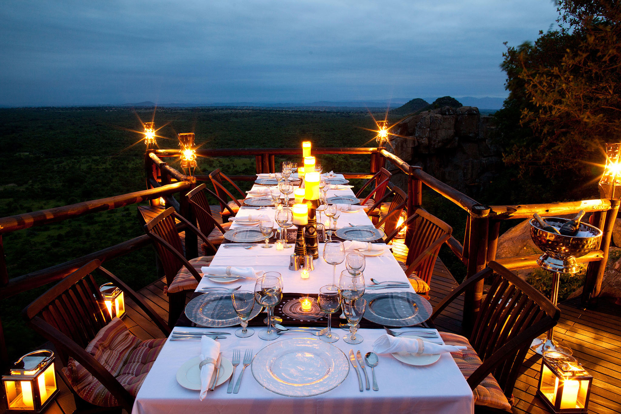dinner table setting on deck of ulusaba rock lodge