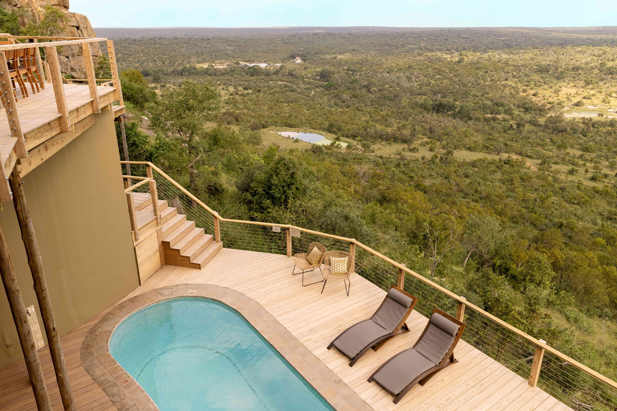 view of pool and chairs on deck of ulusaba cliff lodge