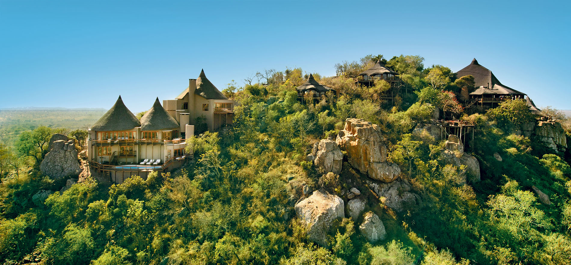 aerial view from the side to show ulusaba rock lodge on the cliff outcroppings