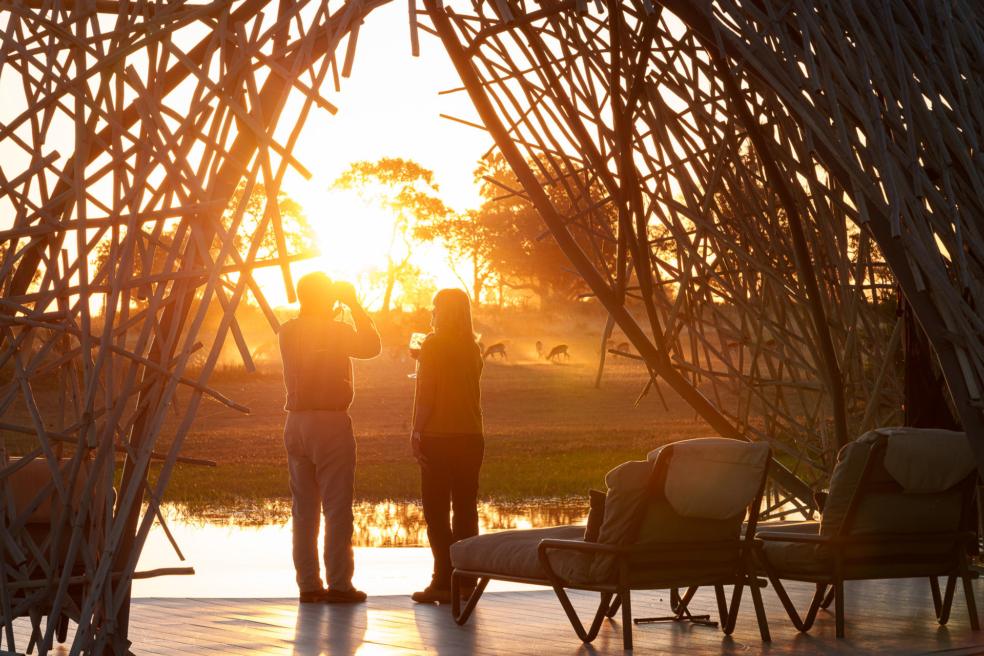 grass dome with guests having sundowners at Jao Camp Wildereness Botswana