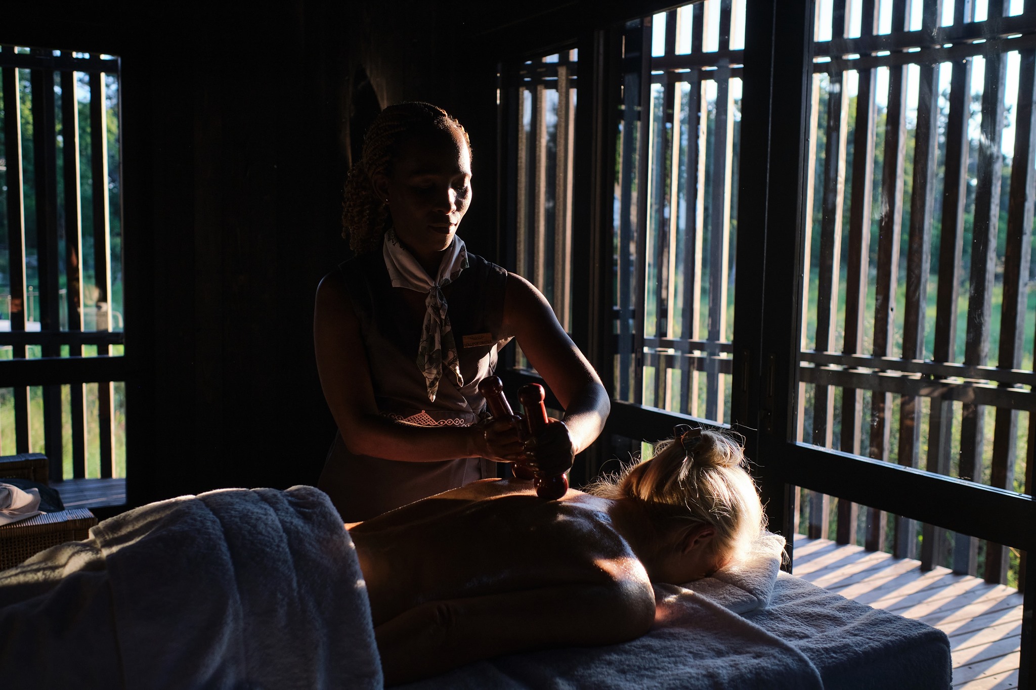 lady guest on message table with treatment at Xigera safari lodge Okavango Delta Bostwana